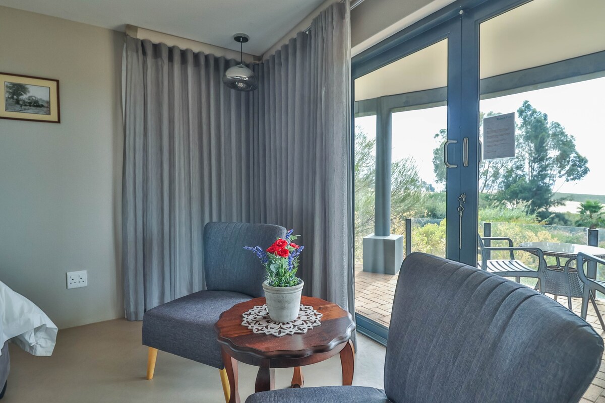 Riebeek Vista guest room seating beside a patio door